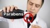 Scientist pouring Parabens into vial